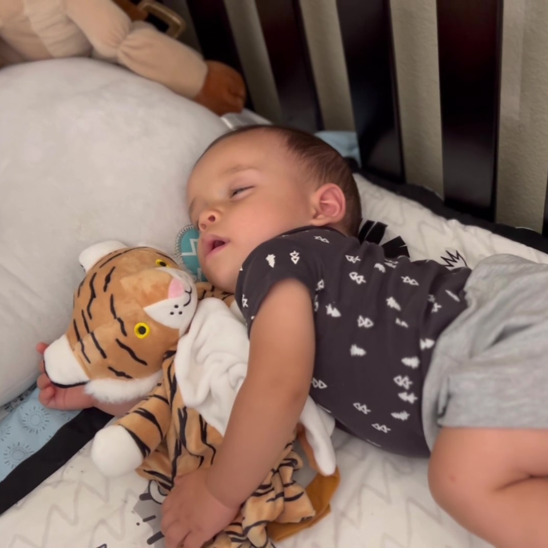 image of boy toddler sleeping peacefully with his love by emi Indi the Tiger musical white noise and lullaby lovey comforter 